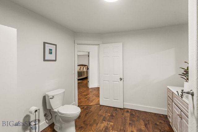 bathroom with vanity, wood-type flooring, and toilet