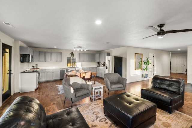 living room featuring light hardwood / wood-style floors and ceiling fan