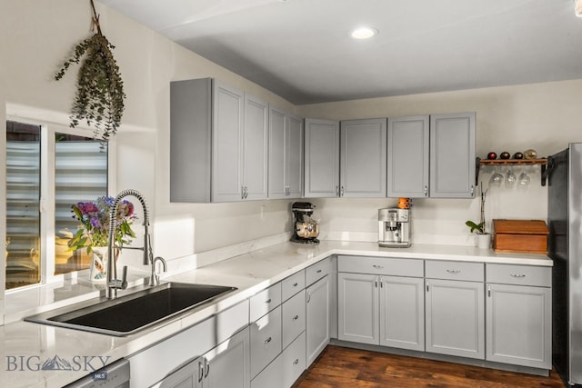 kitchen with dishwashing machine, sink, gray cabinetry, and stainless steel fridge