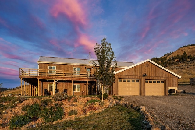 view of front facade with a garage and a deck