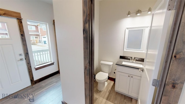 bathroom with vanity, hardwood / wood-style floors, and toilet