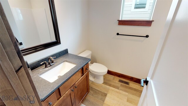 bathroom featuring vanity and toilet