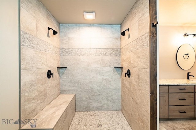 bathroom featuring vanity and a tile shower