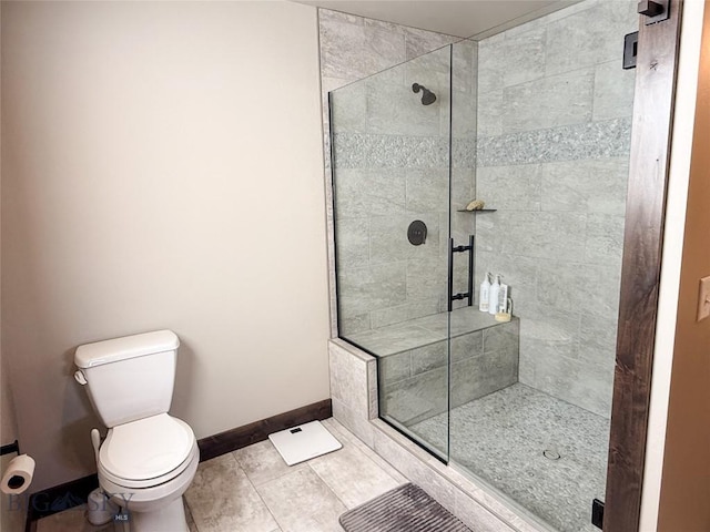 full bath with tile patterned flooring, a shower stall, toilet, and baseboards