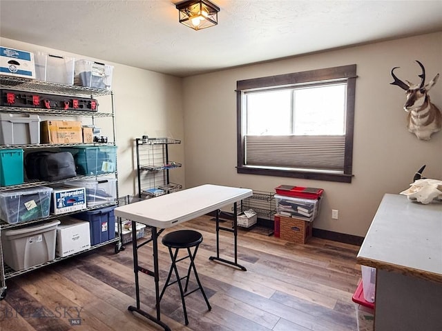 office area with baseboards and wood finished floors