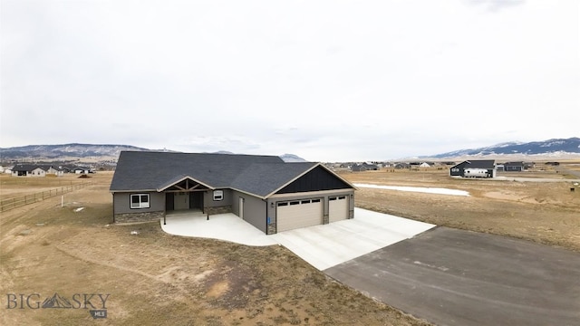 view of front of house featuring a mountain view, driveway, and an attached garage