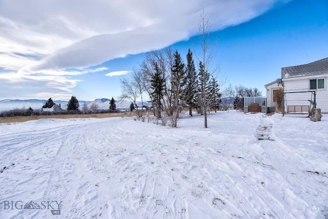 snowy yard featuring a mountain view