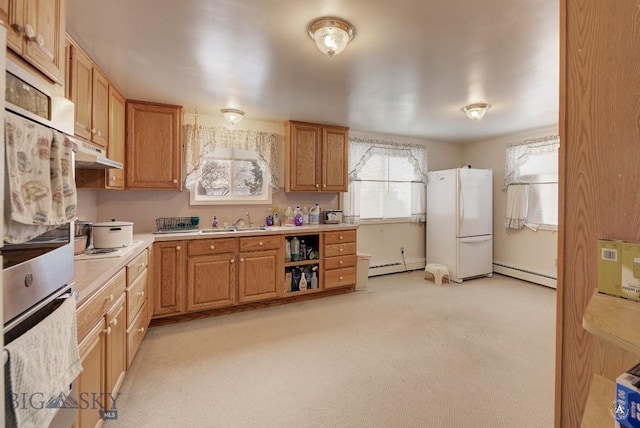 kitchen featuring double oven, sink, a baseboard radiator, and white refrigerator