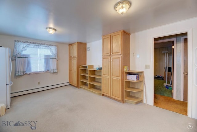 unfurnished bedroom featuring light carpet, a baseboard heating unit, and white refrigerator