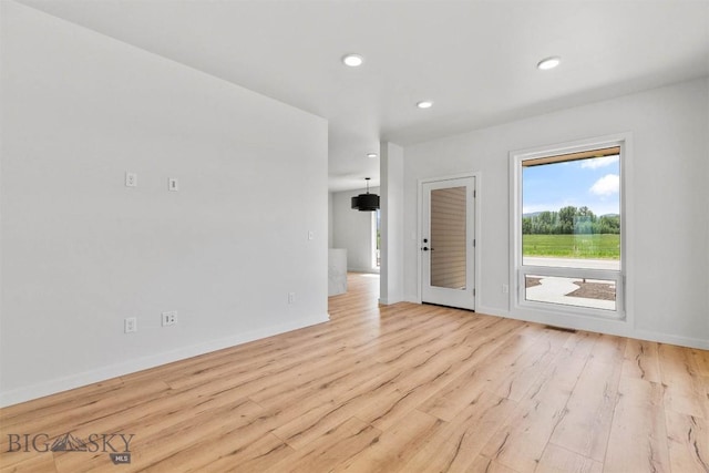 spare room with light hardwood / wood-style floors