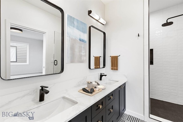 bathroom with vanity and a tile shower