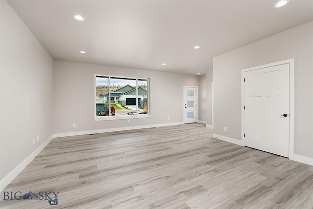 unfurnished living room with light hardwood / wood-style flooring