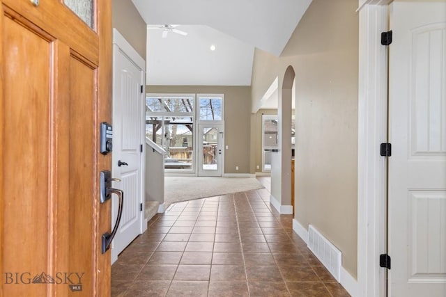 tiled foyer featuring vaulted ceiling and ceiling fan