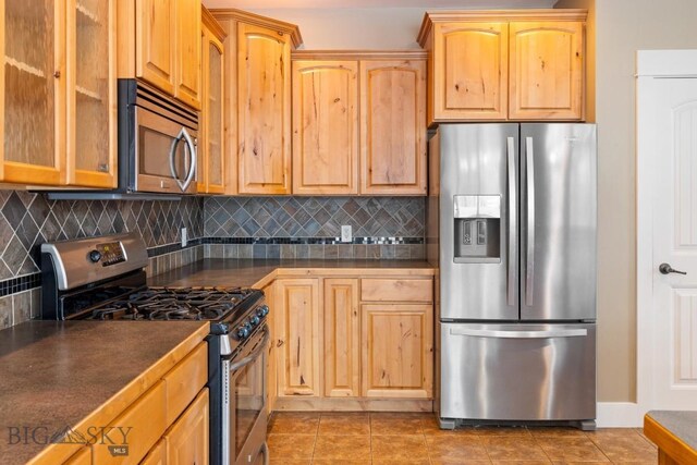 kitchen with stainless steel appliances, tasteful backsplash, and tile patterned floors