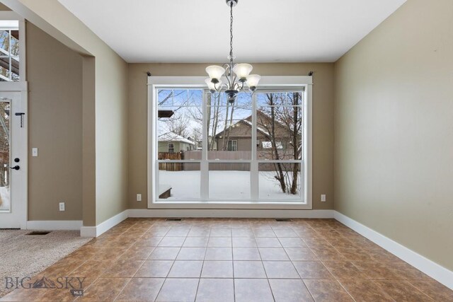 unfurnished dining area with light tile patterned floors and a notable chandelier