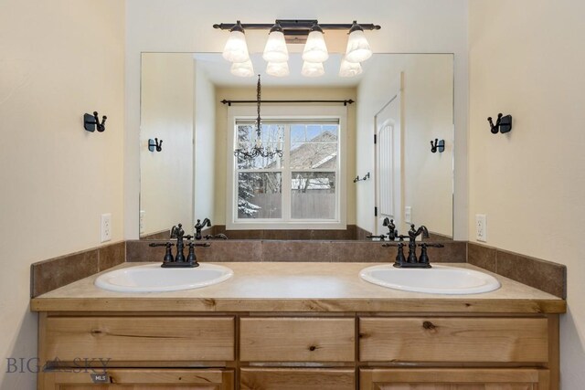 bathroom with vanity and an inviting chandelier