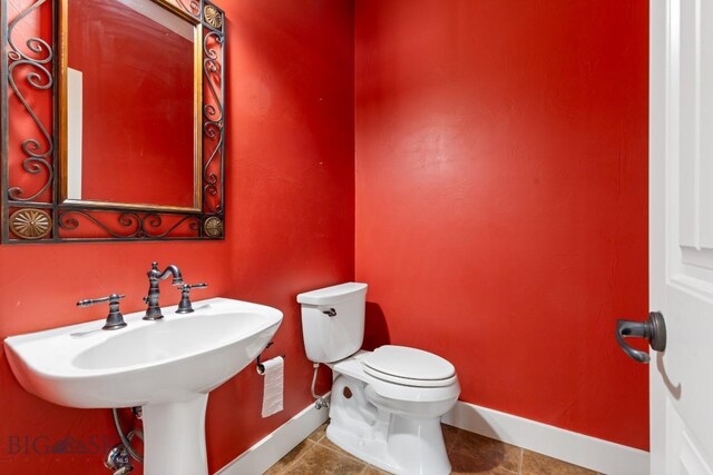 bathroom featuring tile patterned flooring, sink, and toilet