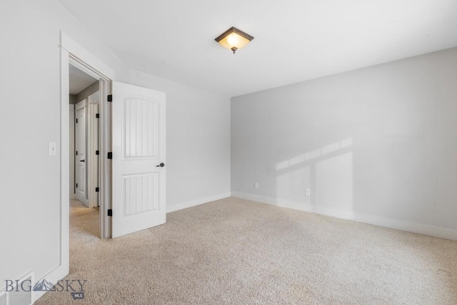 unfurnished room featuring light colored carpet