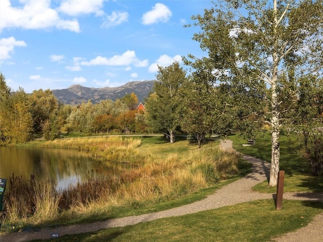 exterior space with a water and mountain view