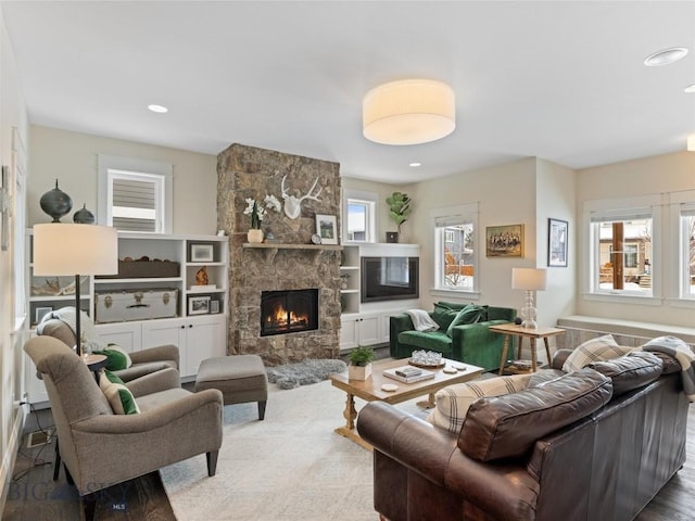 living room featuring a stone fireplace