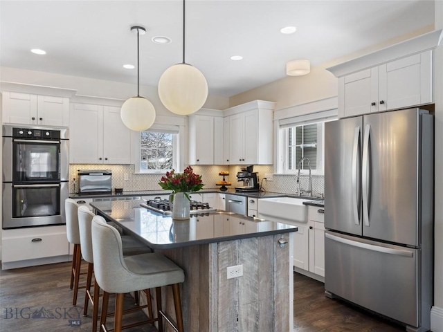 kitchen with white cabinetry, appliances with stainless steel finishes, and sink