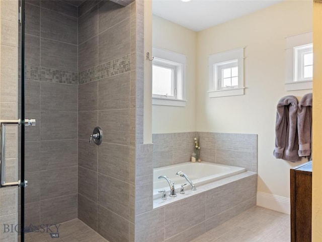 bathroom featuring independent shower and bath