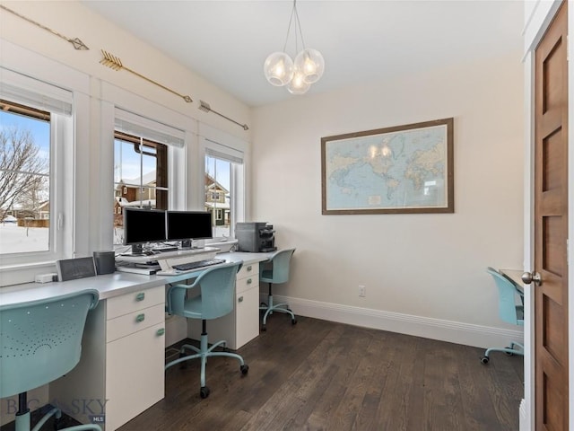 home office with a chandelier and dark hardwood / wood-style flooring