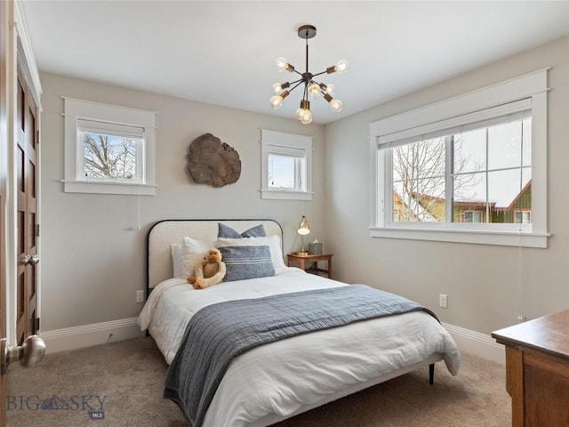 bedroom featuring light colored carpet and a chandelier