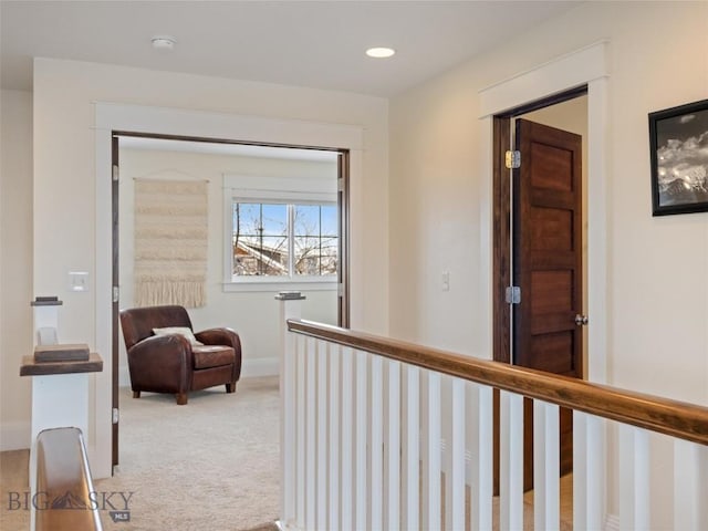 hall with light colored carpet