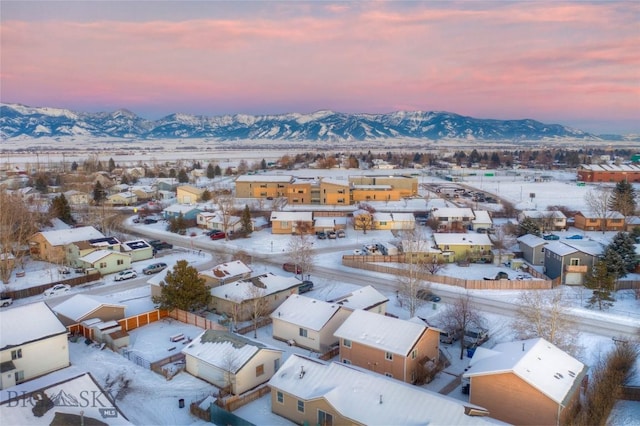 snowy aerial view featuring a mountain view