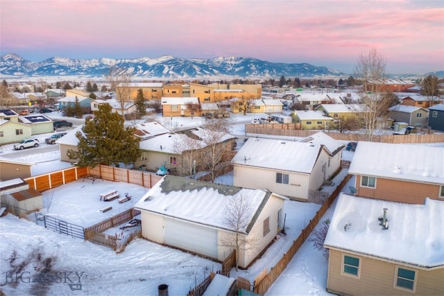 snowy aerial view with a mountain view