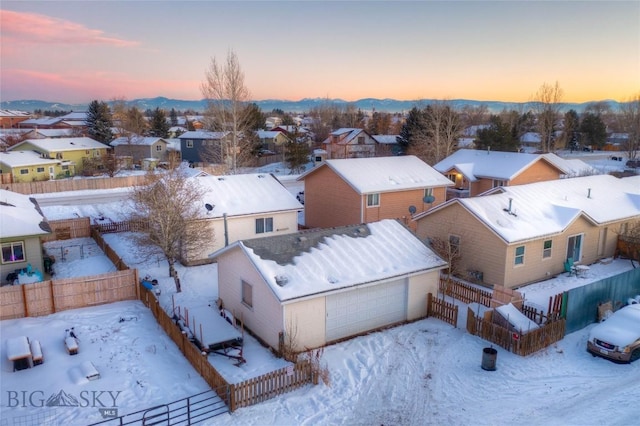 snowy aerial view featuring a mountain view