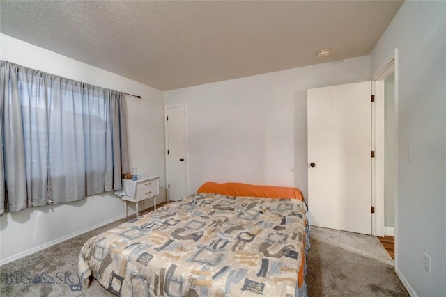 carpeted bedroom featuring a textured ceiling