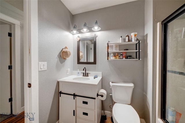 bathroom featuring vanity and toilet