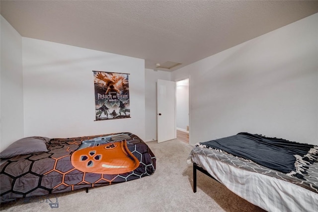 bedroom with carpet floors and a textured ceiling