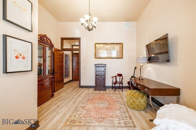 interior space featuring light hardwood / wood-style flooring and a chandelier