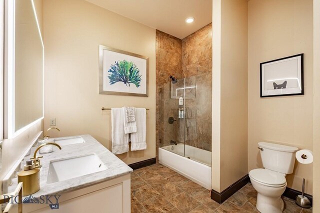 full bathroom with vanity, shower / bath combination with glass door, and toilet