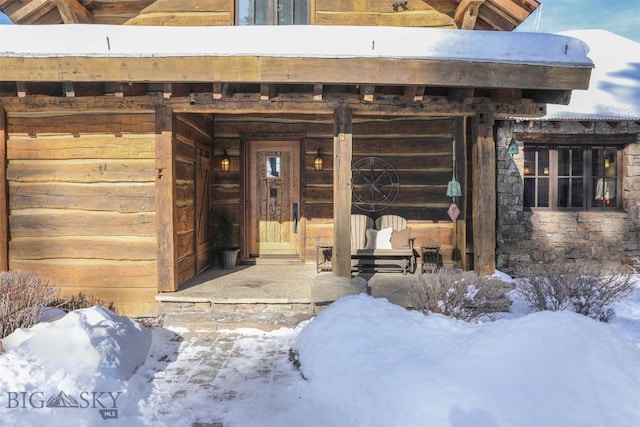 view of snow covered property entrance