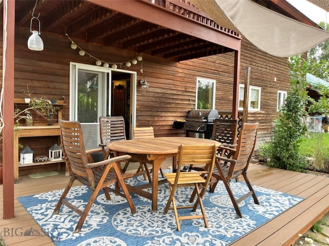 wooden deck featuring a grill