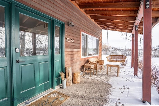 view of snow covered property entrance