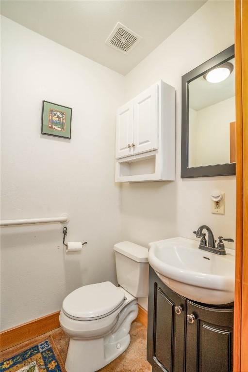 2225 Stagecoach Trail Rd, Manhattan, MT 59741 - bathroom featuring toilet, vanity, baseboards, and wood finished floors