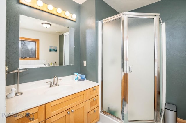 bathroom featuring vanity and a shower with shower door