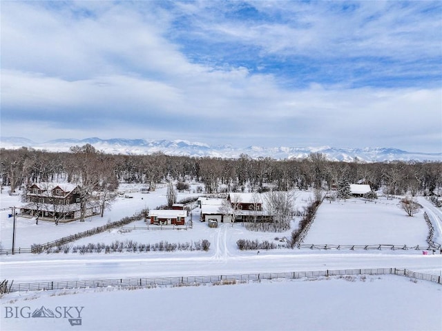 snowy aerial view featuring a mountain view