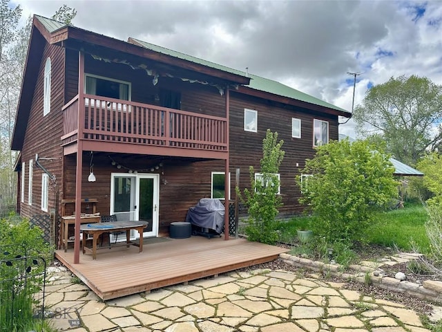 2225 Stagecoach Trail Rd, Manhattan, MT 59741 - back of house featuring a balcony, metal roof, a patio area, and a deck