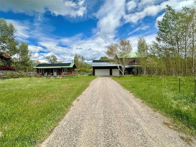 2225 Stagecoach Trail Rd, Manhattan, MT 59741 - view of front of property featuring a garage, driveway, solar panels, a porch, and a front yard