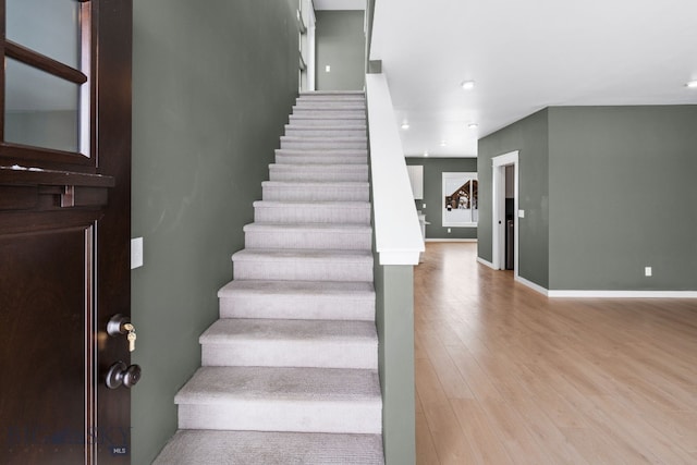 staircase with hardwood / wood-style floors