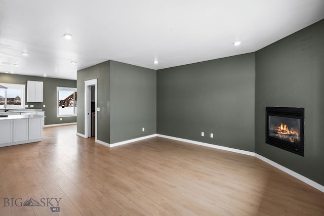 unfurnished living room featuring light hardwood / wood-style flooring