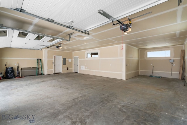 garage featuring a garage door opener and electric panel