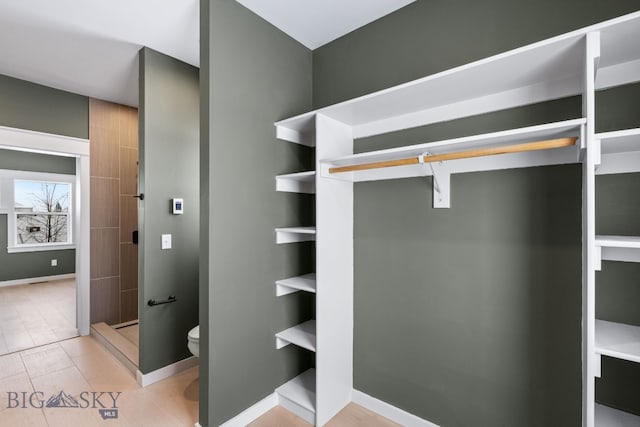 walk in closet featuring tile patterned flooring