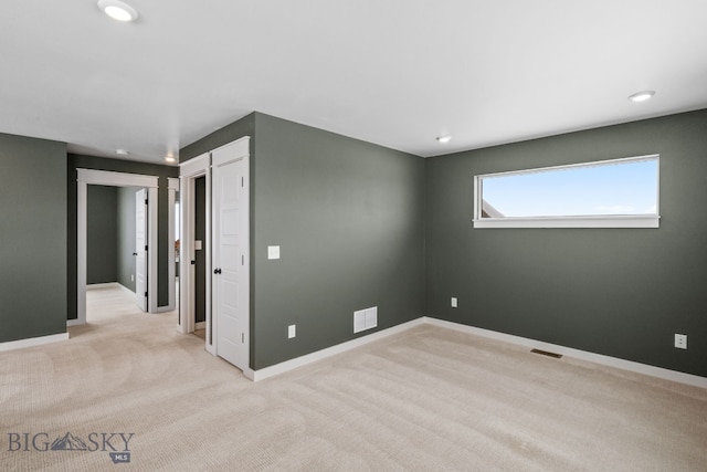 spare room with light colored carpet